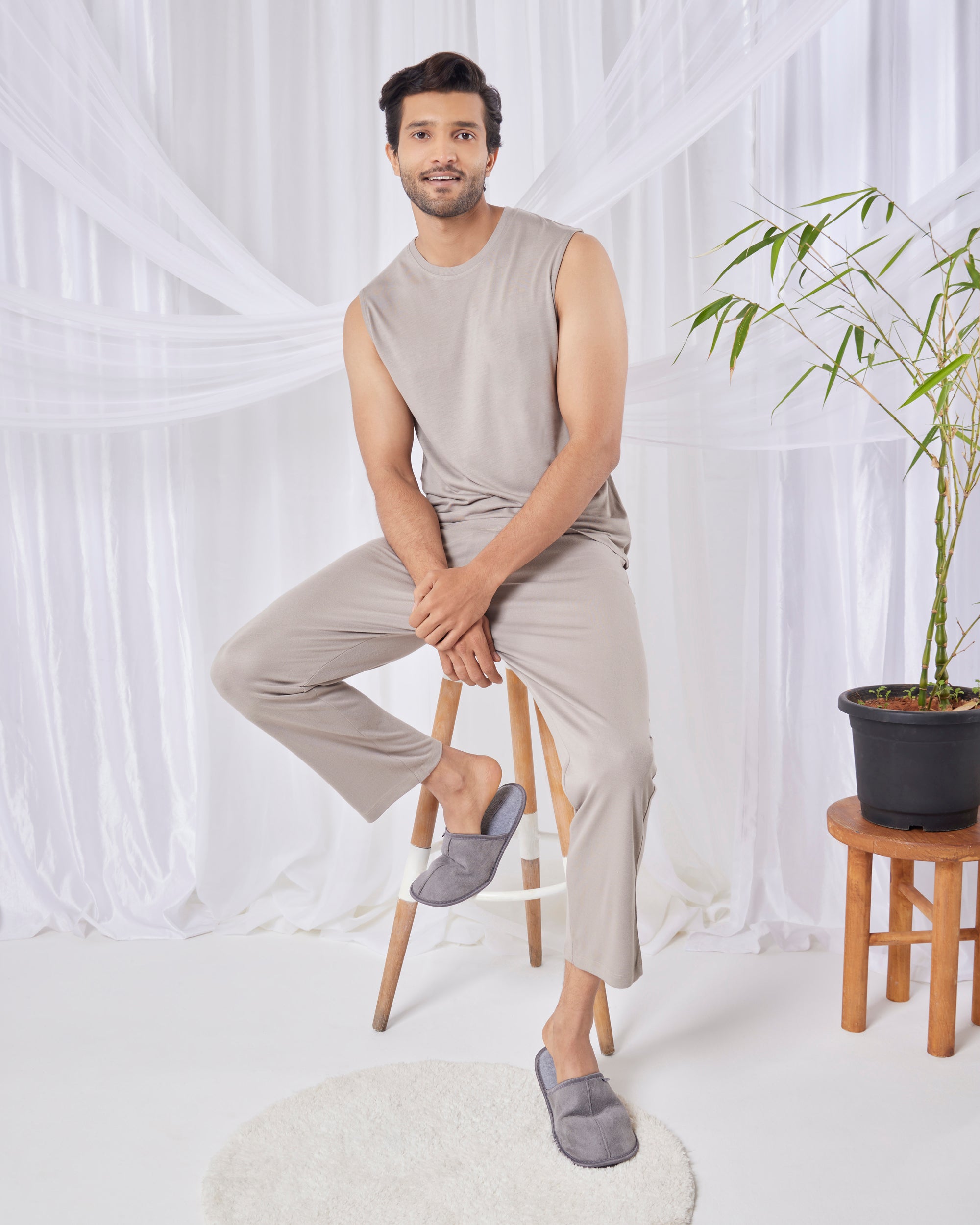 Man sitting on a stool wearing a beige sleeveless top and pants with gray slippers in a minimalistic setting. SoftSleep mens bamboo tee grey mocha lightweight sustainable casual wear. Mens AirKnit tee and pant set in Grey Mocha
Soft breathable loungewear for everyday comfort
Urbanite Bamboo Lounge Pants in Grey Mocha with silky soft feel
Women’s Grey Mocha bamboo pants for nightwear and comfort
Softsleep bamboo pants Grey Mocha, lightweight and breathable
Sustainable bamboo sleep pants in Grey Mocha color